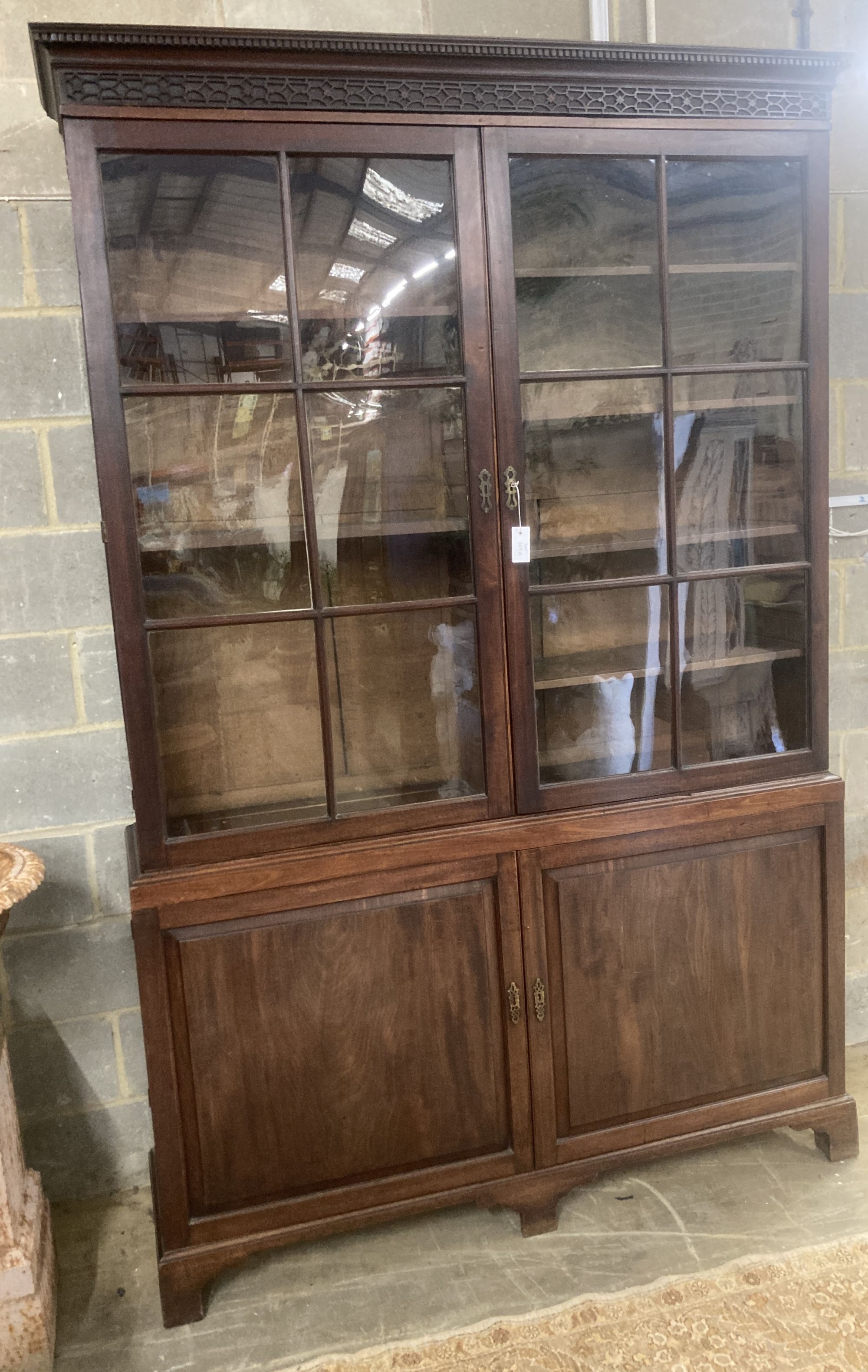 A George III mahogany bookcase cupboard, length 160cm, depth 40cm, height 245cm